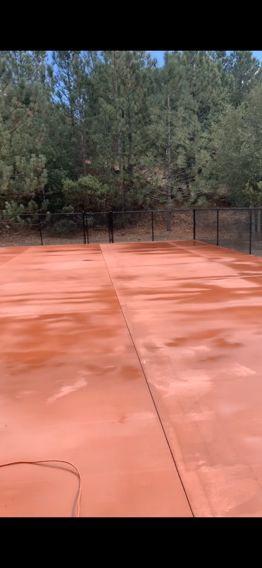Pickleball court mid-resurface with fresh acrylic primer